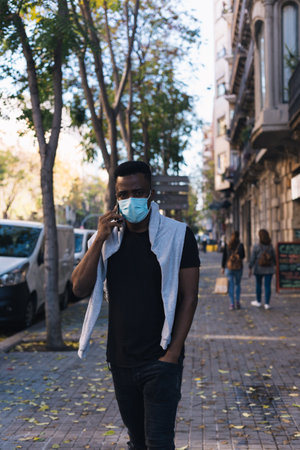 African American looking at the camera just before putting his covid 19 maskの写真素材