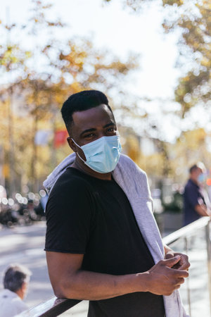 African American looking at the camera just before putting his covid 19 maskの写真素材