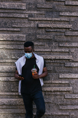 African American looking at the camera just before putting his covid 19 maskの写真素材