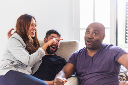 Group of people which are from different places an interracial group having a conversation and laughing and having fun and the black man is surprisedの写真素材
