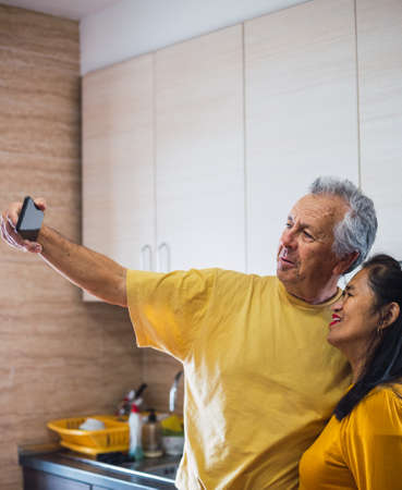 Selfie taken with smartphone in middle age coupleの写真素材