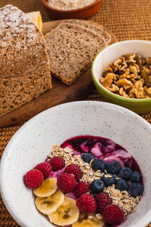 Close up healthy breakfast with a fruit bowl with yogurtの写真素材