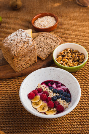 Wealthy breakfast with nuts, yogurt and brown breadの写真素材