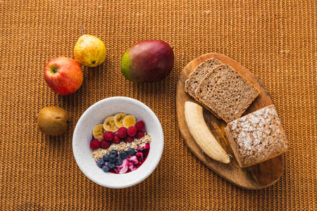 Healthy breakfast with lots of fruits and brown breadの写真素材