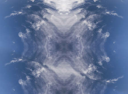 sky with white clouds in a kaleidoscopic composition simulating fantastic figuresの写真素材