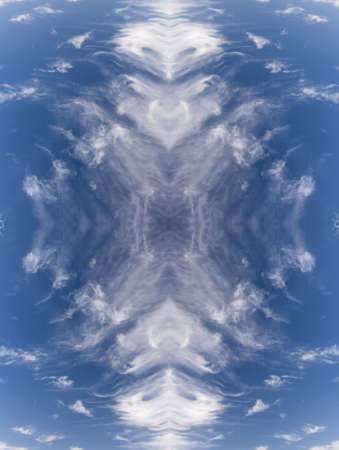 sky with white clouds in a kaleidoscopic composition simulating fantastic figuresの写真素材