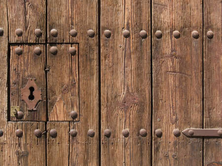ancient and modern lock on old wooden doorの写真素材