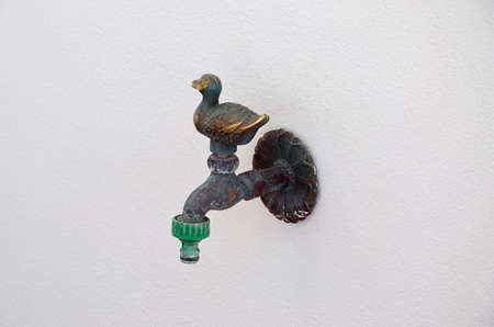 old  tap from metal and white wall