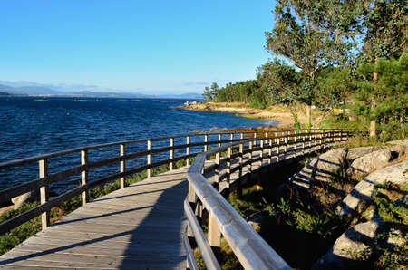 wooden boardwalk by the sea in Galicia, Spainの写真素材