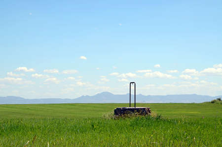 landscape with a water well and mountains and sky with clouds in Extremadura, Spainの写真素材