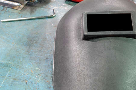 Close-up Welding mask and wrench put on iron tableの写真素材