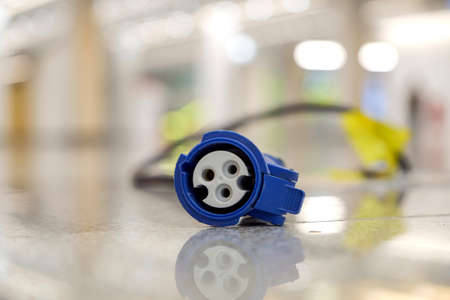 Portrait a modern three eyes plug socket on the floor in the building.の写真素材