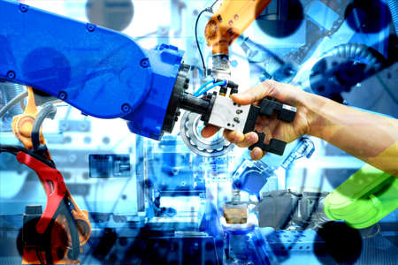 Handshake of robotic and human join for teamwork on smart factory with double exposure image of...