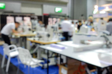 Blurred focus image of labor people, who working on industrial sewing factory for manufacture a garment product, people blurred backgroundの写真素材