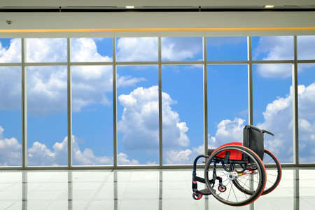 Modern wheelchair parked in empty  room with cloud and sky background, healthcare and medical concept.の写真素材