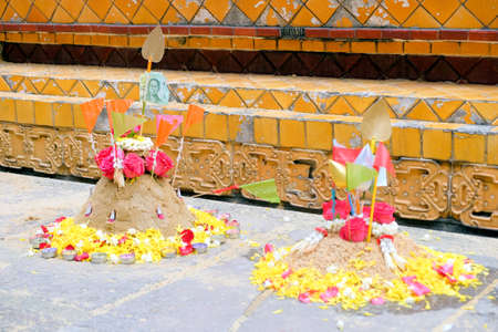 Group of sand pagoda on temple in Songkran Festival, Sand Pagoda is an ancient tradition of the ancient people. And these sand pagodas are also decorated with flags and flowersの写真素材