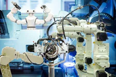 Industrial robotics welding, robotics 3D scan and smart robot working with engine parts on smart factory, on machine blue tone color background, industry 4.0 and technology conceptの写真素材