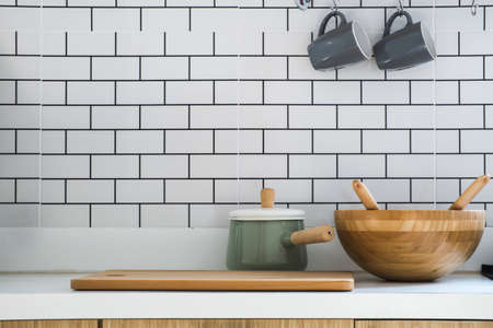 Close-up kitchen room with pot, chopping wood, wooden tub and two ceramic coffee cup put on modern...