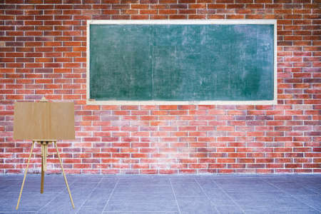 Empty blackboard and blank wooden board easel installed on brick wall retro style on sidewalk of...