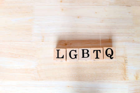 Wooden letters connect to message on wooden desk, informative and communication about alternative gender groups consisting of Lesbian, Gay, Bisexual, Transgender and Queerの写真素材