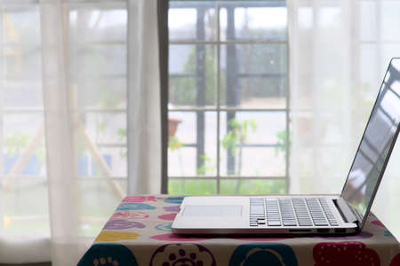 Inside home with portable computer laptop put on small table for work on home, close-up and selective focusの写真素材