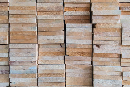 Industrial heads wood rectangle shape of sawed timber material that are stacked in a square on wood warehouse store, wood texture and backgroundの写真素材