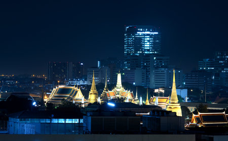 The Grand Palace illuminated with gold light beautifully with surrounded buildings on night scene on...