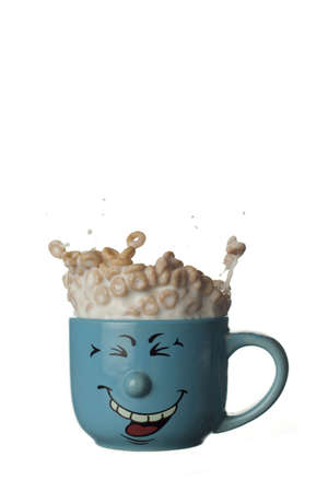 Cereals and milk jumping out of a funny bowlの写真素材