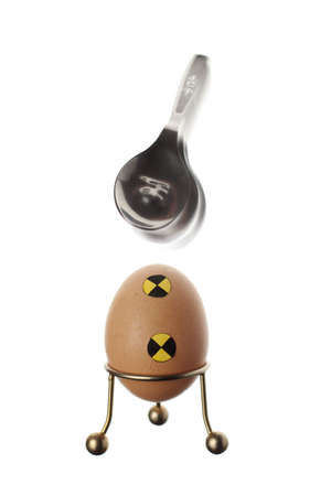 An crash test egg defeating a spoonの写真素材