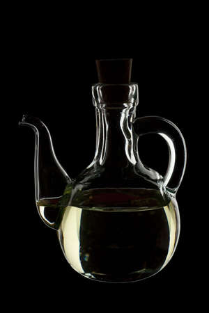 olive oil in a transparent glass isolated on blackの写真素材