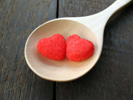 red heart on wooden spoon and old wood backgroundの写真素材