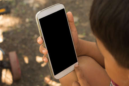 children hand holding smartphone.の写真素材