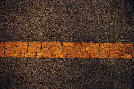 crack yellow line on aphalt road.の写真素材