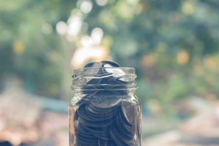 stack of coins full in glass jar,concept for money and  save for future.の写真素材
