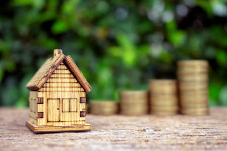 Real estate investment,image house model with stack of coinsの写真素材