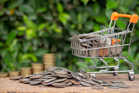 Money saving concept, image of stack coins with cartの写真素材