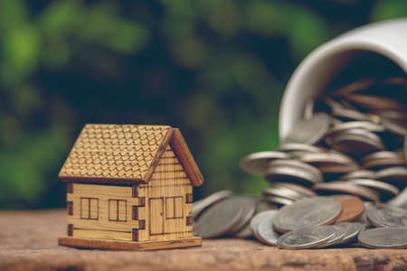 Money estate investment, save for buy new house, image of house model and coins.の写真素材