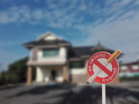 No smoking sign with English and Thai wording on blur houseの写真素材