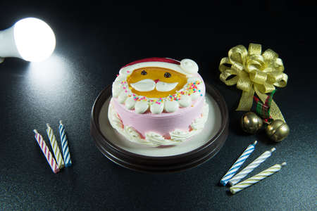 Santa's lovely cake Celebrate Christmas with bells and candles.の写真素材