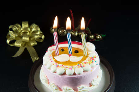 Santa's lovely cake Celebrate Christmas with bells and candles.の写真素材