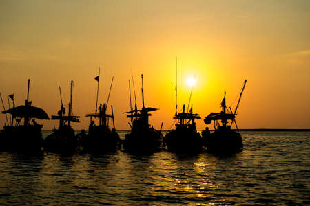 Silhouette local boat with sunset at pangnga, Thailandの写真素材