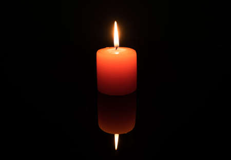 Light a candle on black background