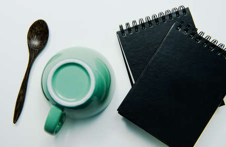 Note book and cup on white background , isolated