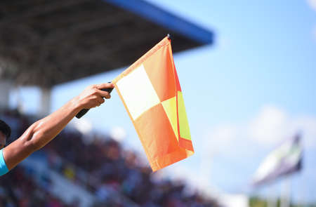 Assistant referee hold flag , offside signalの写真素材