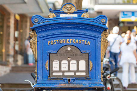 Retro blue letterbox decorated with carved gold figures and an inscription ? ? ?Mailbox? ? in German on itの写真素材