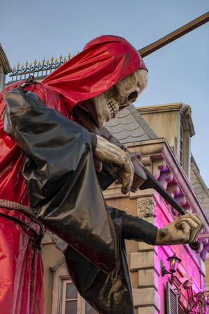 Mysterious red hooded skeleton figure playing violin in front of a mystic castle in the amusement park: September 10 2016 Bad Duerkheim, folkfestival, Germanyのeditorial素材