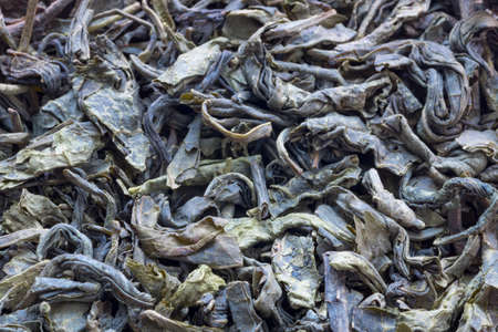 Dry green tea leaves - a textured backgroundの写真素材