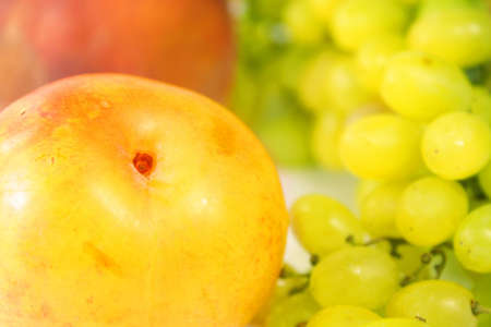 ripe juicy peach and green grape (close up)の写真素材