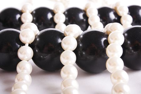 Pearls and black Beads on canvas (close up)の写真素材