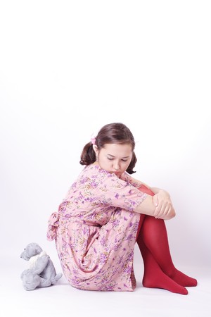 Young beautiful girl on white background with Teddy Bear (isolated)の写真素材